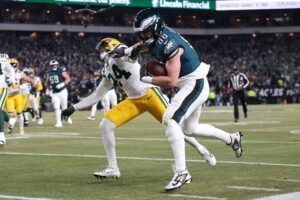 Jan 12, 2025; Philadelphia, Pennsylvania, USA; Philadelphia Eagles tight end Dallas Goedert (88) makes a catch against Green Bay Packers cornerback Carrington Valentine (24) during the third quarter in an NFC wild card game at Lincoln Financial Field.
