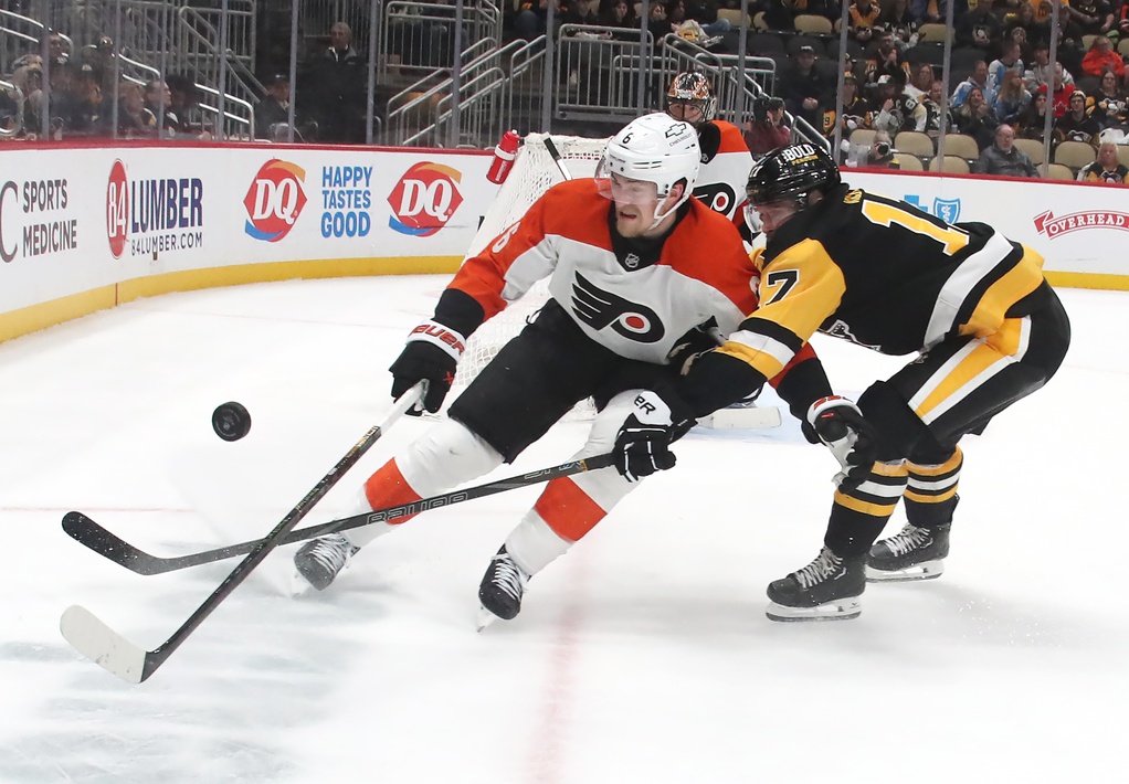 Feb 27, 2025; Pittsburgh, Pennsylvania, USA; Philadelphia Flyers defenseman Travis Sanheim (6) and Pittsburgh Penguins right wing Bryan Rust (17) chase the puck during the third period at PPG Paints Arena.