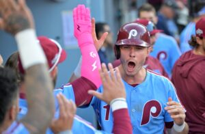 Oct 9, 2025; Los Angeles, California, USA; Philadelphia Phillies left fielder Max Kepler (17) celebrates with teammates after scoring in the seventh inning against the Los Angeles Dodgers during game four of the NLDS round for the 2025 MLB playoffs at Dodger Stadium.
