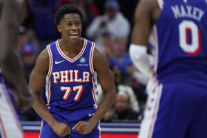 Oct 27, 2025; Philadelphia, Pennsylvania, USA; Philadelphia 76ers guard VJ Edgecombe (77) reacts to guard Tyrese Maxey (0) three pointer against the Orlando Magic during the fourth quarter at Xfinity Mobile Arena.