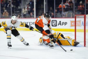 Oct 28, 2025; Philadelphia, Pennsylvania, USA; Philadelphia Flyers right wing Owen Tippett (74) attempts to shoot against Pittsburgh Penguins goalie Arturs Silovs (37) in the third period at Xfinity Mobile Arena.