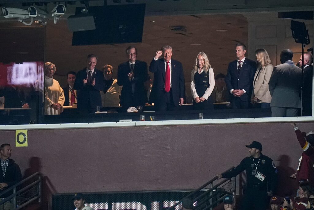 President Donald Trump waves at football fans from the team owner’s suite during the first half between the Detroit Lions and the Washington Commanders at Northwest Stadium in Landover, Md. on Sunday, November 9, 2025.