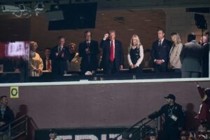 President Donald Trump waves at football fans from the team owner’s suite during the first half between the Detroit Lions and the Washington Commanders at Northwest Stadium in Landover, Md. on Sunday, November 9, 2025.