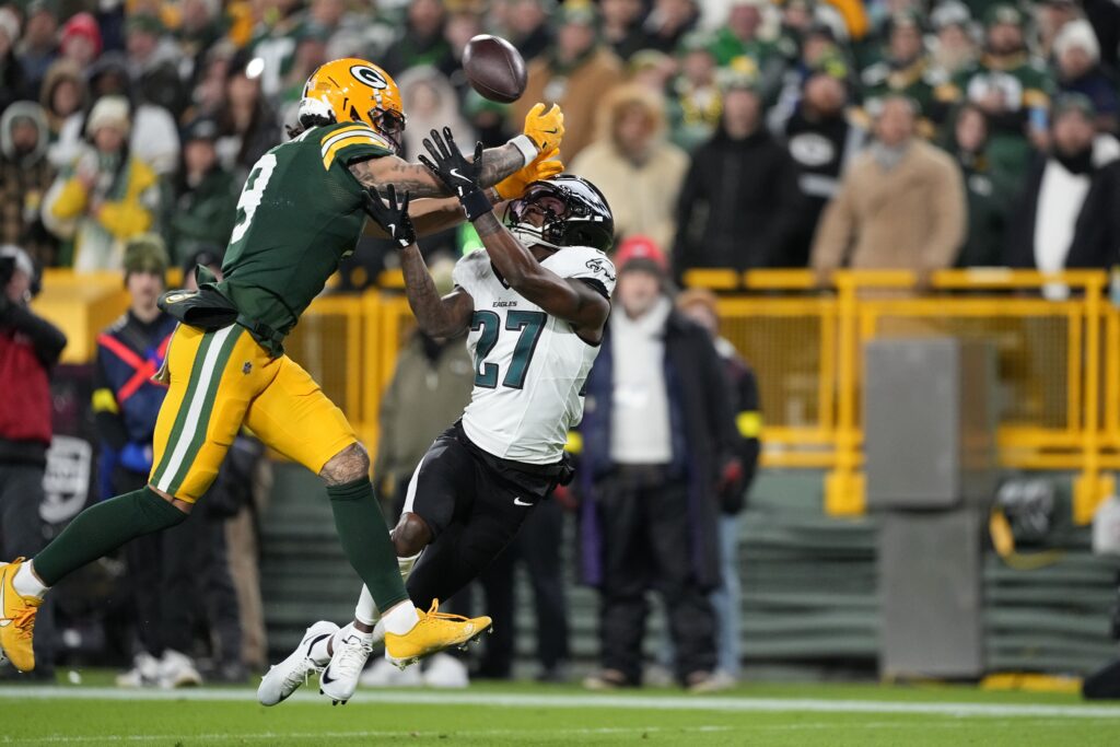 Nov 10, 2025; Green Bay, Wisconsin, USA; Green Bay Packers wide receiver Christian Watson (9) is defended by Philadelphia Eagles cornerback Quinyon Mitchell (27) n the first half at Lambeau Field.