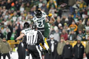 Nov 10, 2025; Green Bay, Wisconsin, USA; Philadelphia Eagles safety Andrew Mukuba (24) bracks up the pass to Green Bay Packers wide receiver Christian Watson (9) in the second half at Lambeau Field.
