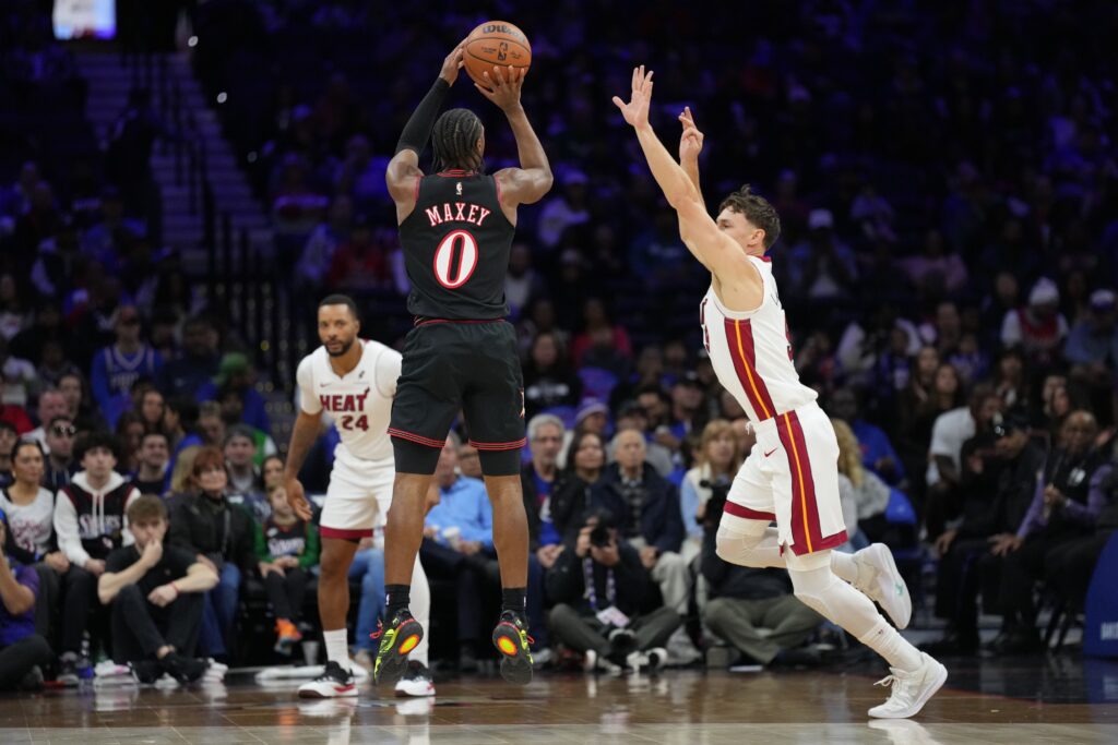 Nov 23, 2025; Philadelphia, Pennsylvania, USA; Philadelphia 76ers guard Tyrese Maxey (0) shoots the ball against Miami Heat guard Pelle Larsson (9) in the first quarter at Xfinity Mobile Arena.