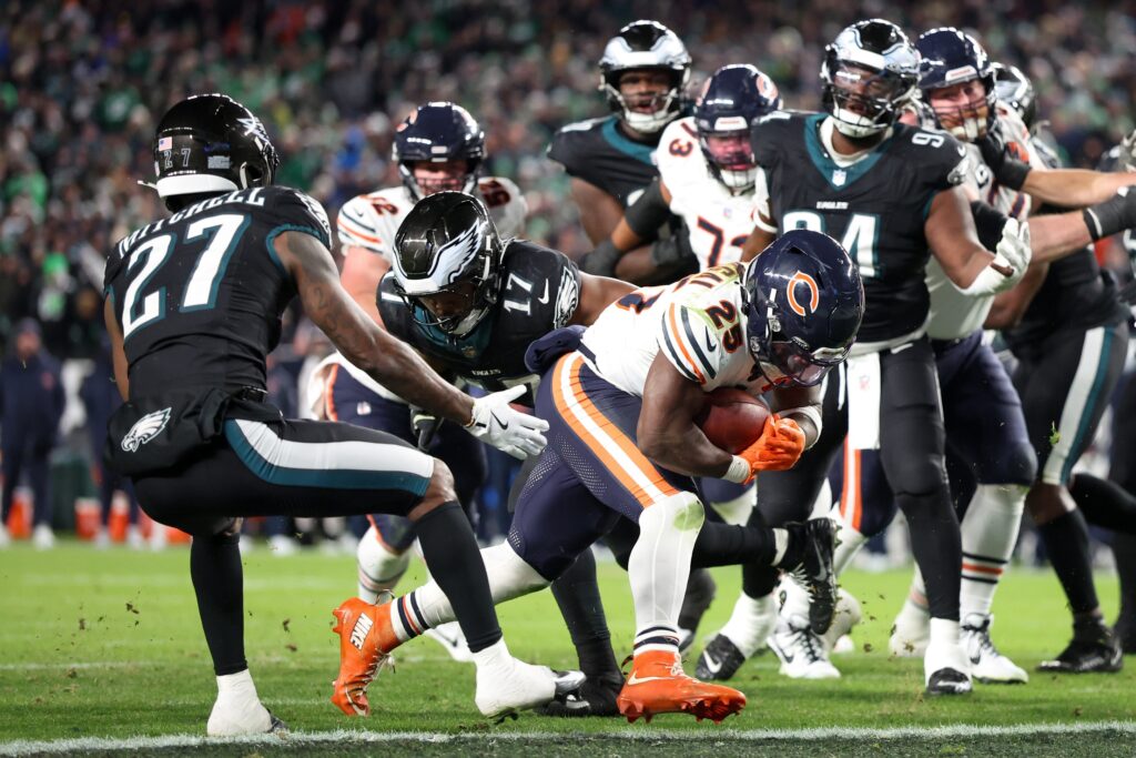 Nov 28, 2025; Philadelphia, Pennsylvania, USA; Chicago Bears running back Kyle Monangai (25) carries the ball for a touchdown defended by Philadelphia Eagles cornerback Quinyon Mitchell (27) and linebacker Nakobe Dean (17) during the fourth quarter of the game at Lincoln Financial Field.