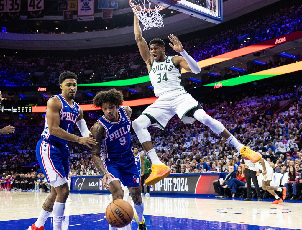 Oct 23, 2024; Philadelphia, Pennsylvania, USA; Milwaukee Bucks forward Giannis Antetokounmpo (34) dunks the ball past Philadelphia 76ers guard Kelly Oubre Jr. (9) during the first quarter at Wells Fargo Center.