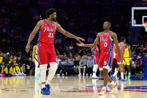 Dec 13, 2024; Philadelphia, Pennsylvania, USA; Philadelphia 76ers center Joel Embiid (21) and guard Tyrese Maxey (0) slap hands after a play against the Indiana Pacers during the first quarter at Wells Fargo Center.