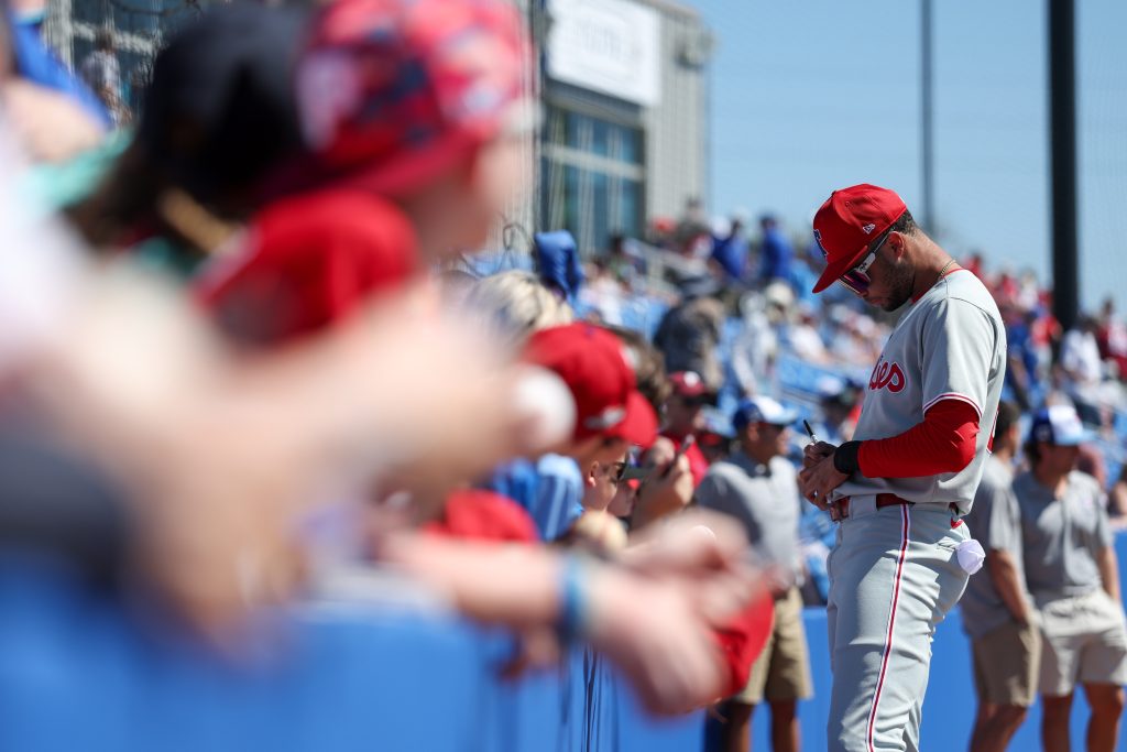 Mar 2, 2025; Dunedin, Florida, USA; Philadelphia Phillies outfielder Justin Crawford (80) signs autographs for fans before a game against the Toronto Blue Jays during spring training at TD Ballpark.