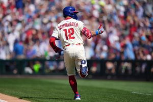 Sep 14, 2025; Philadelphia, Pennsylvania, USA; Philadelphia Phillies designated hitter Kyle Schwarber (12) reacts after hitting a home run against the Kansas City Royals in the first inning at Citizens Bank Park.