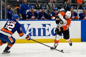 Nov 28, 2025; Elmont, New York, USA; New York Islanders center Kyle MacLean (32) blocks the shot by Philadelphia Flyers right wing Matvei Michkov (39) during the third period at UBS Arena.