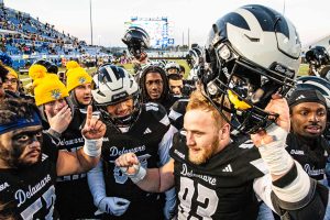 Delaware defensive tackle Jack Hall (93) holds up his helmet in celebration with team members over Delaware’s 61-31 victory against UTEP in the Conference USA football season finale at Delaware Stadium in Newark on Nov. 29, 2025. Delaware won 61-31.