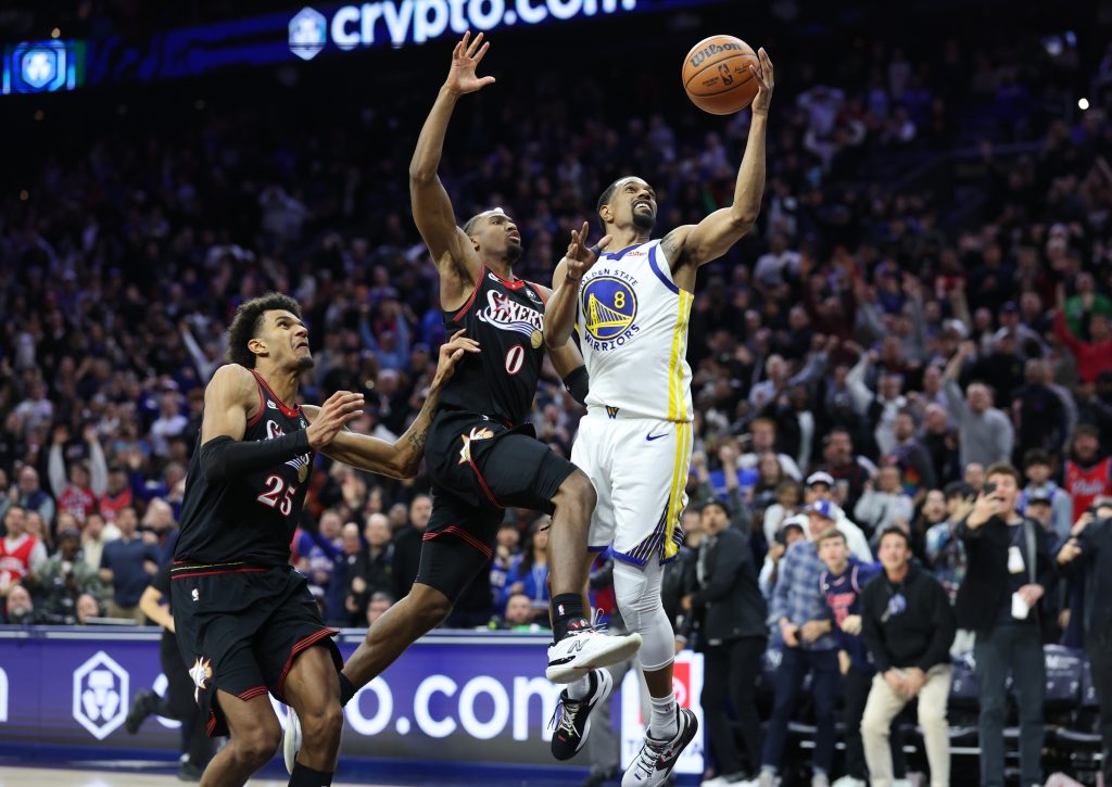 Dec 4, 2025; Philadelphia, Pennsylvania, USA; Philadelphia 76ers guard Tyrese Maxey (0) blocks the final shot of the game by Golden State Warriors guard De'Anthony Melton (8) to secure the victory at Xfinity Mobile Arena.