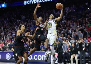 Dec 4, 2025; Philadelphia, Pennsylvania, USA; Philadelphia 76ers guard Tyrese Maxey (0) blocks the final shot of the game by Golden State Warriors guard De'Anthony Melton (8) to secure the victory at Xfinity Mobile Arena.