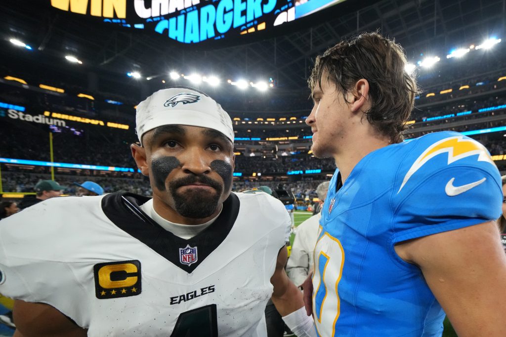 Dec 8, 2025; Inglewood, California, USA; Los Angeles Chargers quarterback Justin Herbert (10) embraces Philadelphia Eagles quarterback Jalen Hurts (1) after the game at SoFi Stadium.