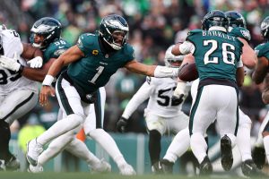 Dec 14, 2025; Philadelphia, Pennsylvania, USA; Philadelphia Eagles quarterback Jalen Hurts (1) hands off to running back Saquon Barkley (26) during the third quarter against the Las Vegas Raiders at Lincoln Financial Field.