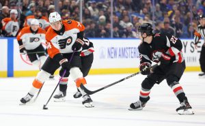 Dec 18, 2025; Buffalo, New York, USA; Philadelphia Flyers right wing Owen Tippett (74) controls the puck as Buffalo Sabres right wing Jack Quinn (22) defends during the first period at KeyBank Center.