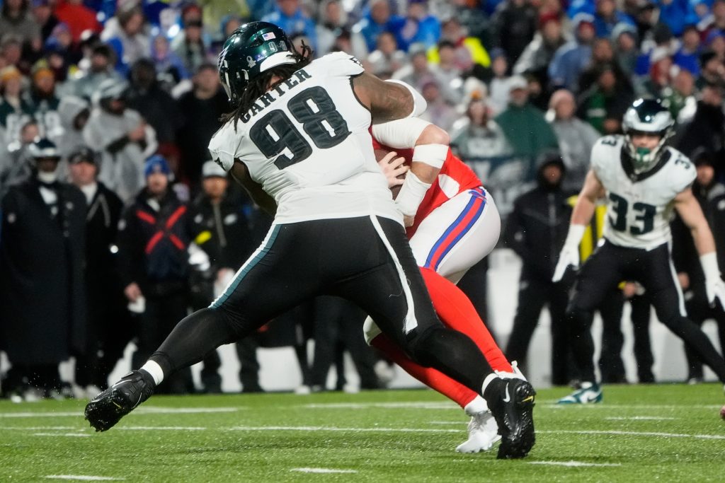 Dec 28, 2025; Orchard Park, New York, USA; Philadelphia Eagles defensive tackle Jalen Carter (98) sacks Buffalo Bills quarterback Josh Allen (17) during the second quarter at Highmark Stadium.