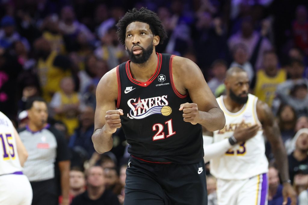 Dec 7, 2025; Philadelphia, Pennsylvania, USA; Philadelphia 76ers center Joel Embiid (21) reacts to a score against the Los Angeles Lakers during the fourth quarter at Xfinity Mobile Arena.