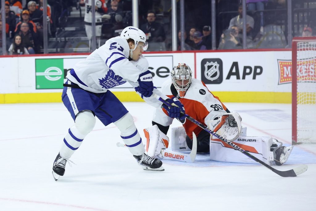 Jan 8, 2026; Philadelphia, Pennsylvania, USA; Philadelphia Flyers goaltender Dan Vladar (80) makes a save on Toronto Maple Leafs right wing Easton Cowan (53) during overtime at Xfinity Mobile Arena.