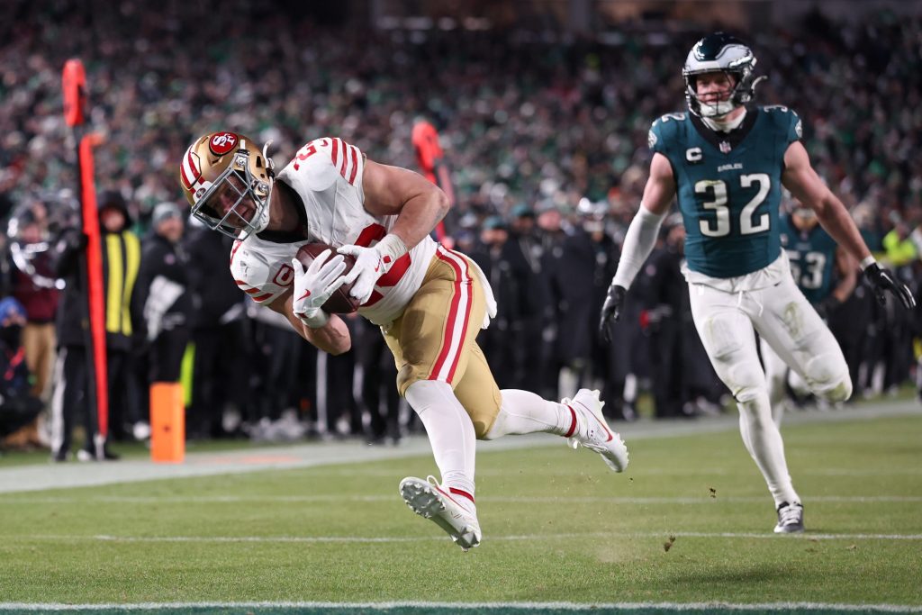 Jan 11, 2026; Philadelphia, PA, USA; San Francisco 49ers running back Christian McCaffrey (23) makes a catch for a touchdown defended by Philadelphia Eagles safety Reed Blankenship (32) during the fourth quarter in an NFC Wild Card Round game at Lincoln Financial Field.