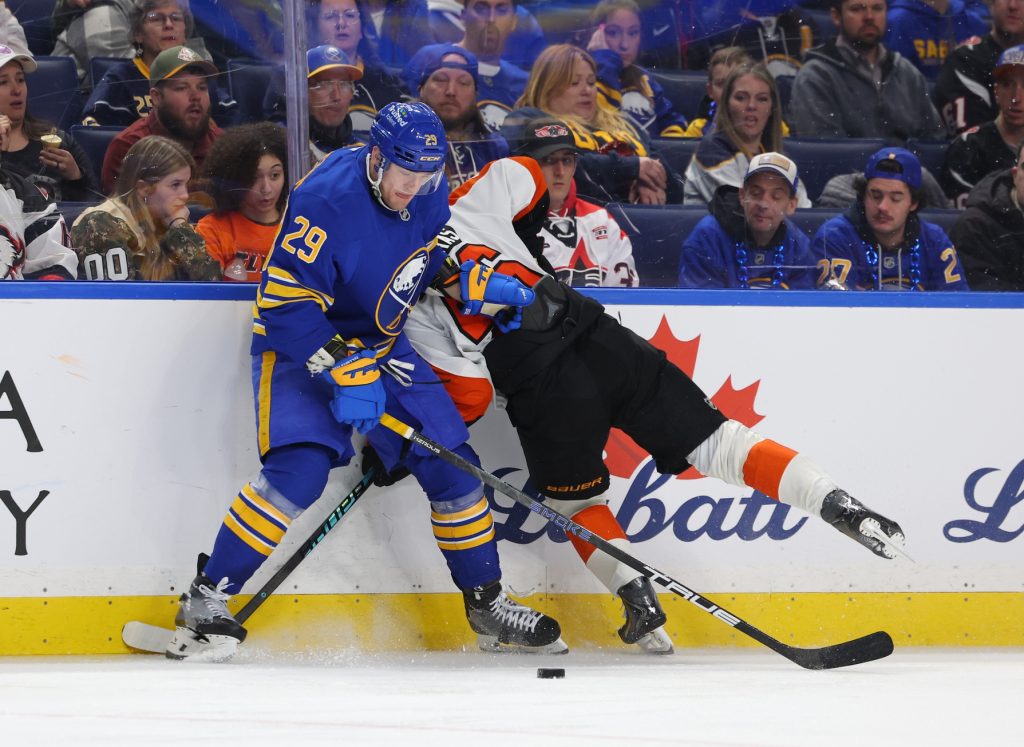 Jan 14, 2026; Buffalo, New York, USA; Buffalo Sabres left wing Beck Malenstyn (29) checks Philadelphia Flyers center Trevor Zegras (46) as he goes after the puck during the third period at KeyBank Center.