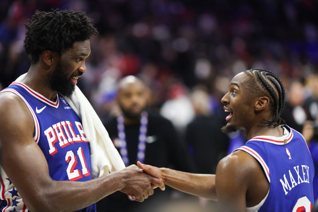 Jan 22, 2026; Philadelphia, Pennsylvania, USA; Philadelphia 76ers center Joel Embiid (21) and guard Tyrese Maxey (0) celebrate after an overtime win against the Houston Rockets at Xfinity Mobile Arena.