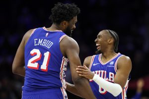Jan 27, 2026; Philadelphia, Pennsylvania, USA; Philadelphia 76ers center Joel Embiid (21) celebrates with guard Tyrese Maxey (0) after their alley oop dunk connection against the Milwaukee Bucks during the second quarter at Xfinity Mobile Arena.