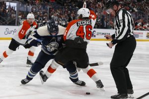 Jan 28, 2026; Columbus, Ohio, USA; Philadelphia Flyers center Trevor Zegras (46) and Columbus Blue Jackets center Isac Lundestrom (21) battle for the puck after a face-off during the third period at Nationwide Arena.