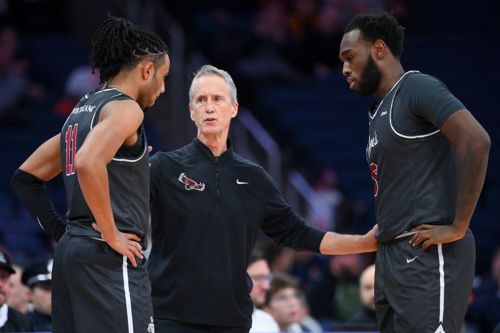 Dec 11, 2025; Syracuse, New York, USA; Saint Joseph's Hawks head coach Steve Donahue (center) talke with guard Jaiden Glover-Toscano (left) and forward Anthony Finkley (right) against the Syracuse Orange during the first half at the JMA Wireless Dome.