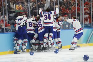 Feb 22, 2026; Milan, Italy; Jack Hughes (86) of the United States is congratulated by teammates after scoring the game-winning goal against Canada in the men's ice hockey gold medal game during the Milano Cortina 2026 Olympic Winter Games at Milano Santagiulia Ice Hockey Arena. Mandatory Credit: