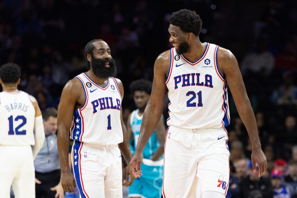 Oct 12, 2022; Philadelphia, Pennsylvania, USA; Philadelphia 76ers center Joel Embiid (21) talks with guard James Harden (1) after a score against the Charlotte Hornets during the first quarter at Wells Fargo Center.