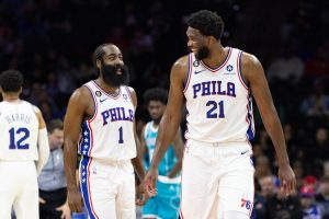 Oct 12, 2022; Philadelphia, Pennsylvania, USA; Philadelphia 76ers center Joel Embiid (21) talks with guard James Harden (1) after a score against the Charlotte Hornets during the first quarter at Wells Fargo Center.