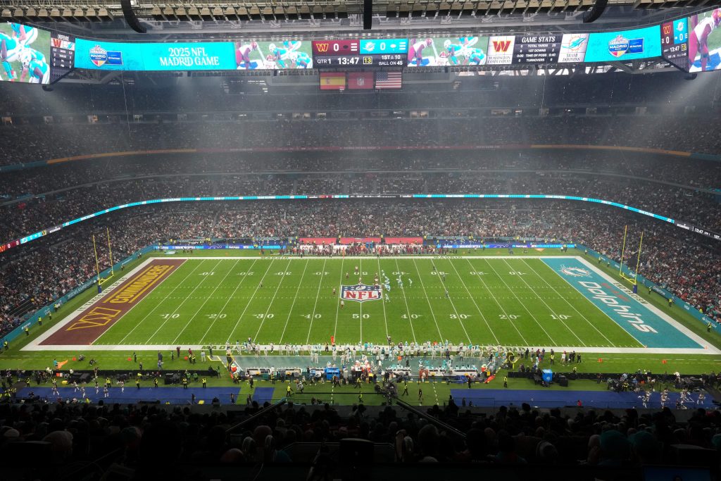 Nov 16, 2025; Madrid, Spain; The Miami Dolphins offense takes on the Washington Commanders defense in the first quarter during the 2025 NFL Madrid Game at Santiago Bernabeu Stadium.