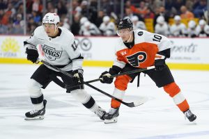 Jan 31, 2026; Philadelphia, Pennsylvania, USA; Los Angeles Kings left wing Trevor Moore (12) and Philadelphia Flyers right wing Bobby Brink (10) battle for position in the first period at Xfinity Mobile Arena.