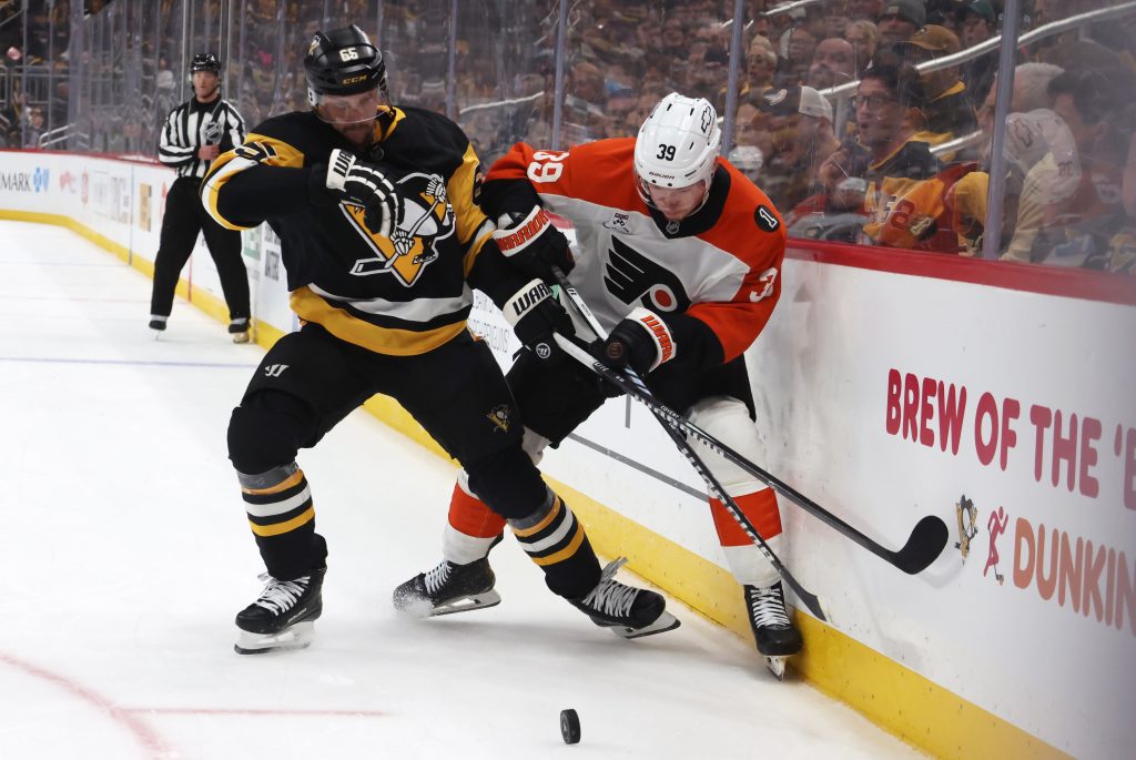 Mar 7, 2026; Pittsburgh, Pennsylvania, USA; Pittsburgh Penguins defenseman Erik Karlsson (65) and Philadelphia Flyers right wing Matvei Michkov (39) battle for the puck during the third period at PPG Paints Arena.
