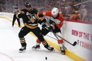 Mar 7, 2026; Pittsburgh, Pennsylvania, USA; Pittsburgh Penguins defenseman Erik Karlsson (65) and Philadelphia Flyers right wing Matvei Michkov (39) battle for the puck during the third period at PPG Paints Arena.
