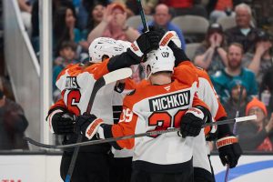 Mar 21, 2026; San Jose, California, USA; Philadelphia Flyers center Christian Dvorak (22) (obscured) celebrates with teammates after scoring a goal against the San Jose Sharks during the third period at SAP Center at San Jose.