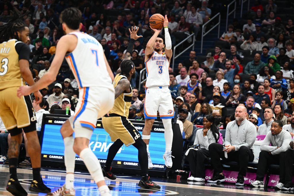 Mar 21, 2026; Washington, District of Columbia, USA; Oklahoma City Thunder guard Jared McCain (3) over Washington Wizards center Alex Sarr (20) during the second half at Capital One Arena.