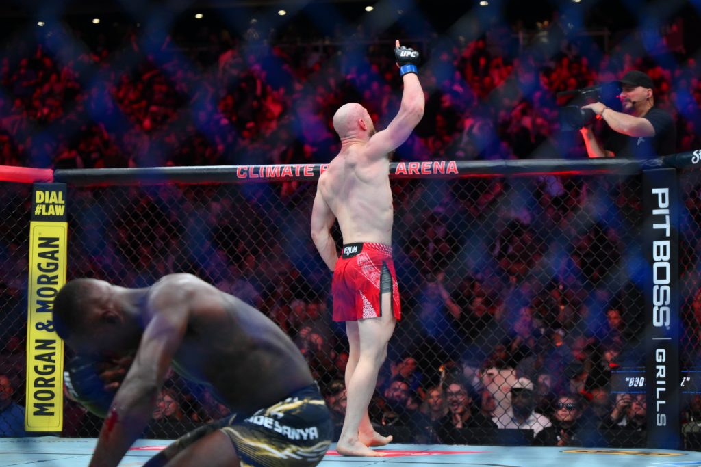 Mar 28, 2026; Seattle, Washington, USA; Joe Pyfer (blue gloves) reacts after defeating Israel Adesanya (red gloves) during UFC Fight Night at Climate Pledge Arena.