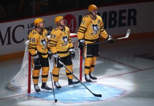 Oct 9, 2025; Pittsburgh, Pennsylvania, USA; Pittsburgh Penguins defenseman Kris Letang (58) and center Sidney Crosby (87) and center Evgeni Malkin (71) stand as they are recognized as the longest tenured teammates in North American professional sports history before their twentieth season together prior to the game against the New York Islanders at PPG Paints Arena.