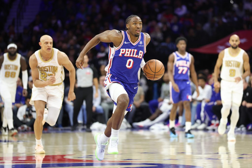 Nov 11, 2025; Philadelphia, Pennsylvania, USA; Philadelphia 76ers guard Tyrese Maxey (0) dribbles up court past the Boston Celtics during the third quarter at Xfinity Mobile Arena.