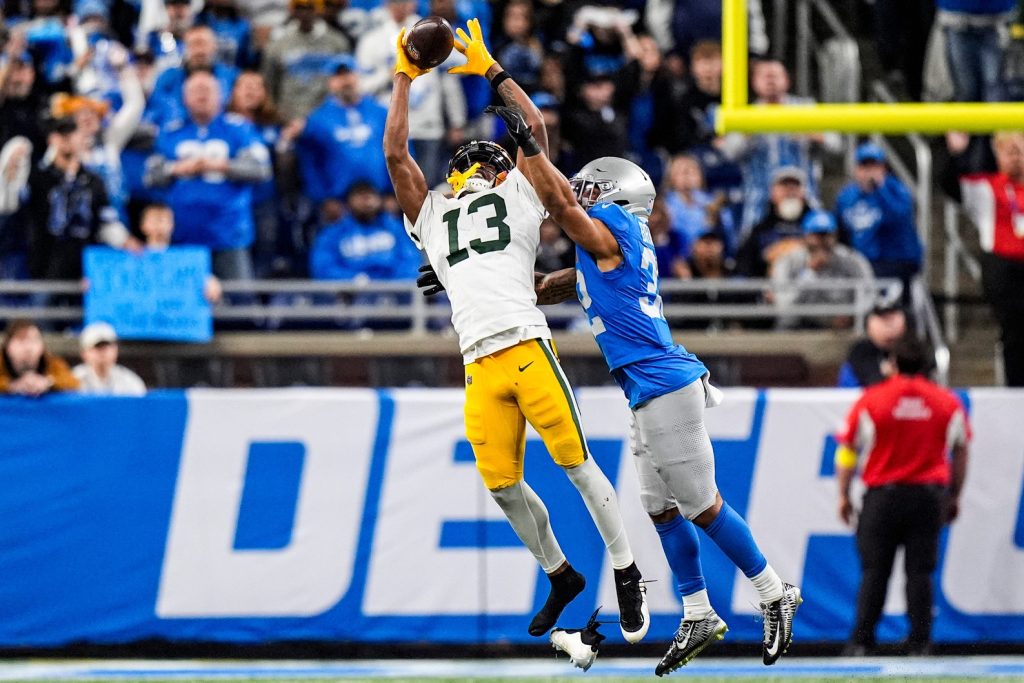 Green Bay Packers wide receiver Dontayvion Wicks (13) makes a catch against Detroit Lions safety Brian Branch (32) during the second half at Ford Field in Detroit on Thursday, Nov. 27, 2025.
