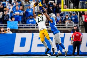 Green Bay Packers wide receiver Dontayvion Wicks (13) makes a catch against Detroit Lions safety Brian Branch (32) during the second half at Ford Field in Detroit on Thursday, Nov. 27, 2025.
