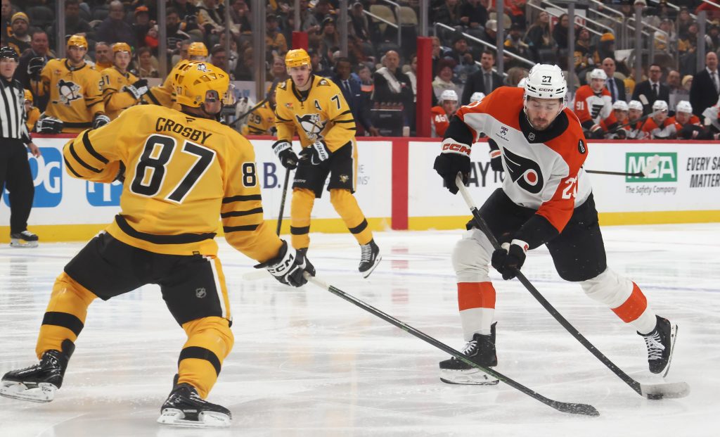 Jan 15, 2026; Pittsburgh, Pennsylvania, USA; Philadelphia Flyers left wing Noah Cates (27) shoots the puck as Pittsburgh Penguins center Sidney Crosby (87) defends during the first period at PPG Paints Arena.