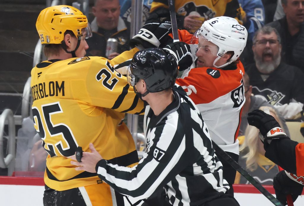 Apr 18, 2026; Pittsburgh, Pennsylvania, USA; Pittsburgh Penguins left wing Elmer Soderblom (25) and Philadelphia Flyers defenseman Travis Sanheim (6) tussle as linesman linesman Devin Berg (87) separates the two during the first period against in game one of the first round of the 2026 Stanley Cup Playoffs at PPG Paints Arena.