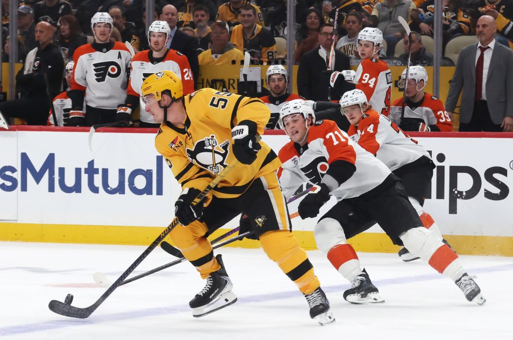 Apr 20, 2026; Pittsburgh, Pennsylvania, USA; Pittsburgh Penguins center Noel Acciari (55) moves the puck up ice against Philadelphia Flyers right wing Tyson Foerster (71) during the second period in game two of the first round of the 2026 Stanley Cup Playoffs at PPG Paints Arena.