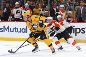 Apr 20, 2026; Pittsburgh, Pennsylvania, USA; Pittsburgh Penguins center Noel Acciari (55) moves the puck up ice against Philadelphia Flyers right wing Tyson Foerster (71) during the second period in game two of the first round of the 2026 Stanley Cup Playoffs at PPG Paints Arena.