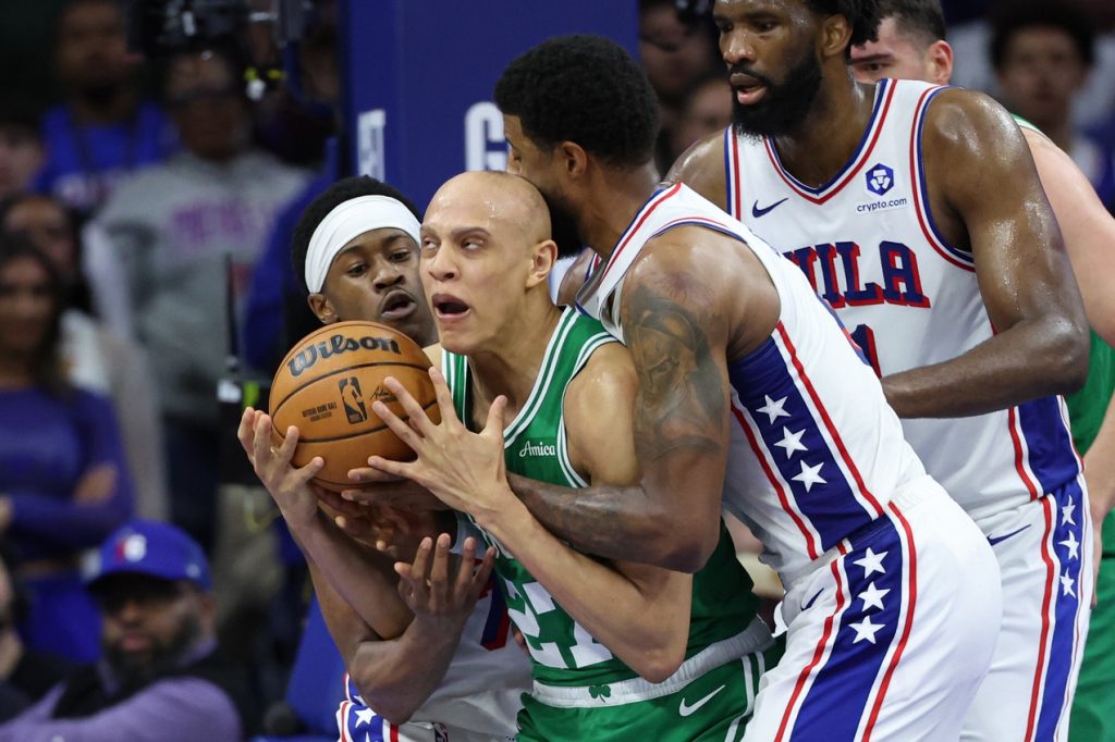 Apr 30, 2026; Philadelphia, Pennsylvania, USA; Boston Celtics guard Jordan Walsh (27) and Philadelphia 76ers guard Vj Edgecombe (77) and forward Paul George (8) wrestle for the ball during the fourth quarter at Xfinity Mobile Arena.